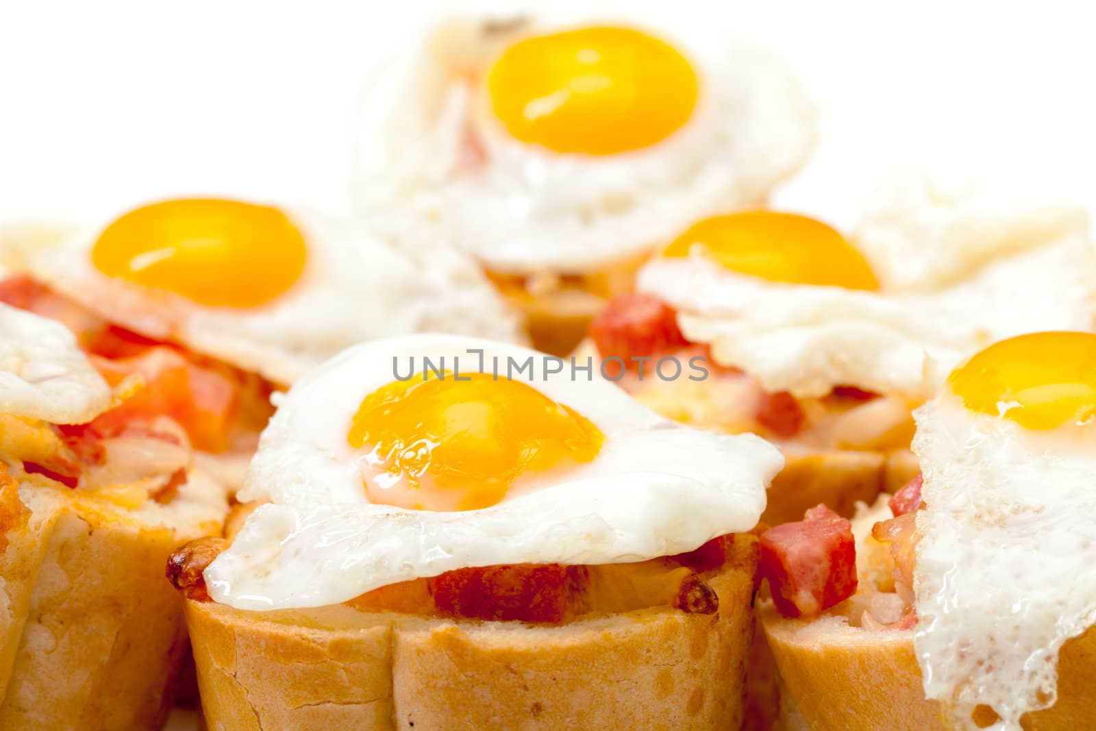 Baguette Slice with Ham and Fried Quail Egg, closeup