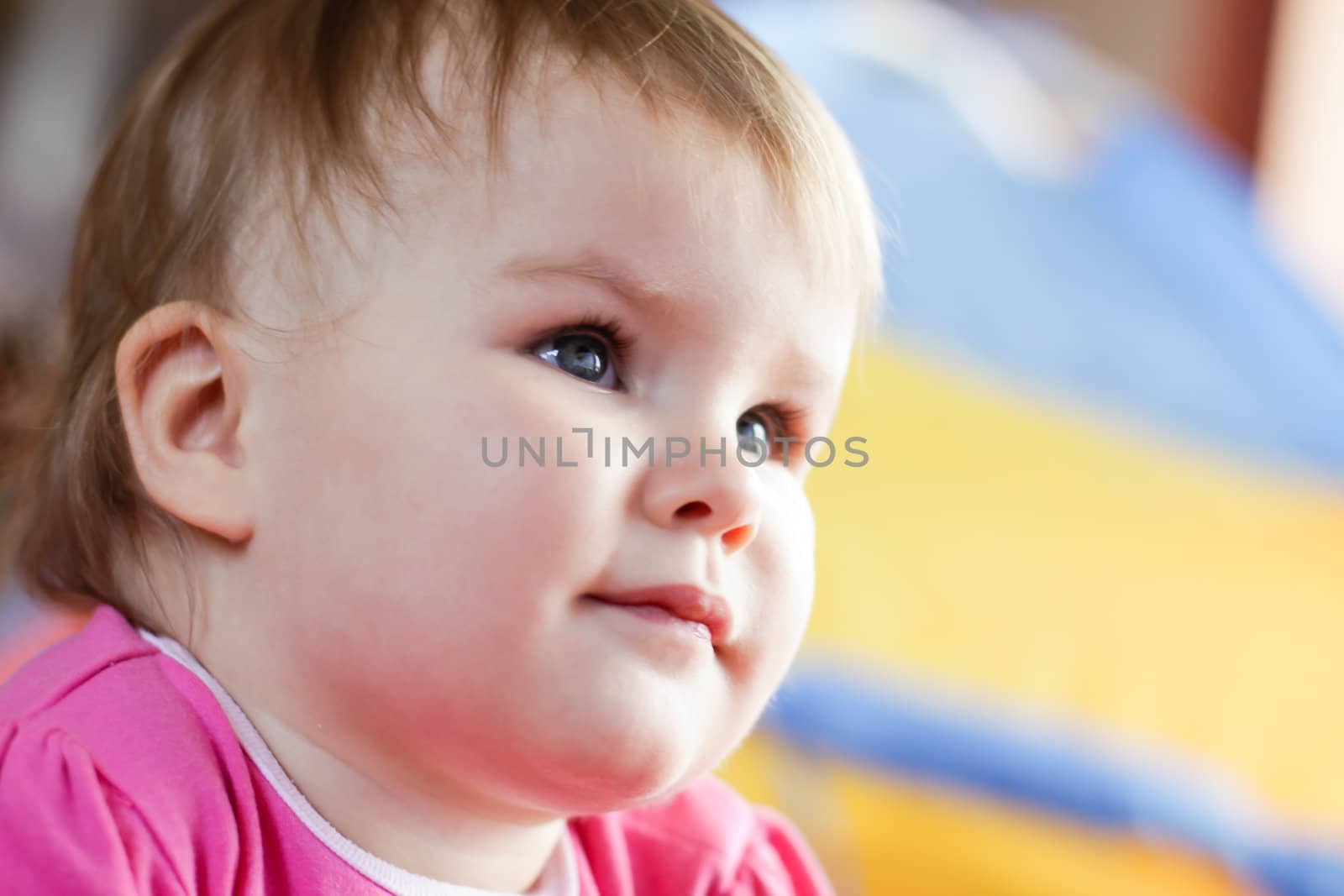 Baby girl watching tv at home