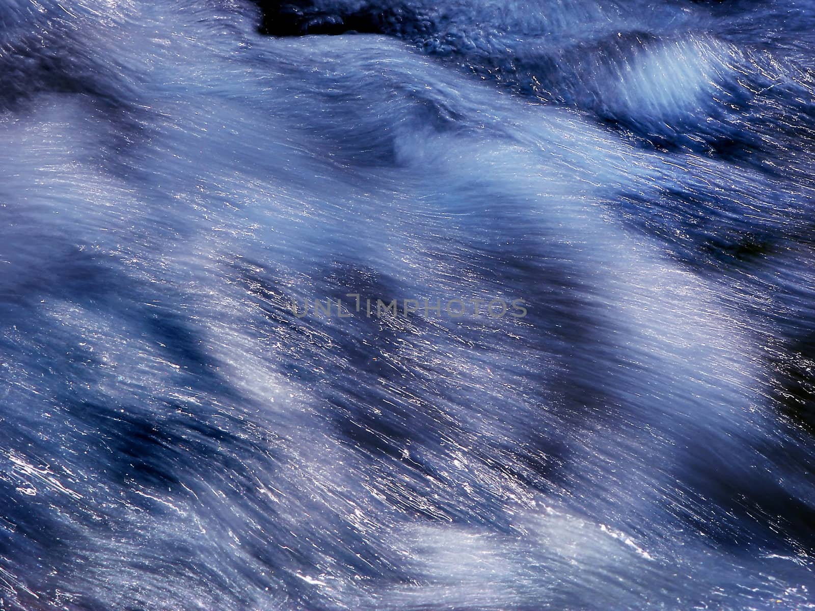 The speed and the energy of the water of a mountain river is caught with this frame.