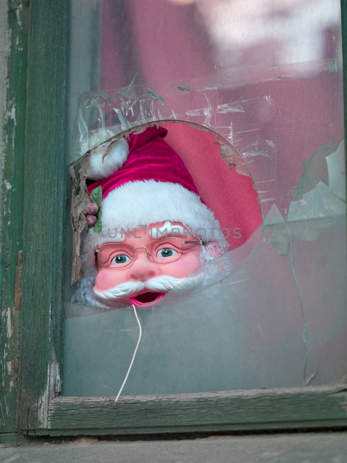 Close-up shot of Father Santa mask of broken window.