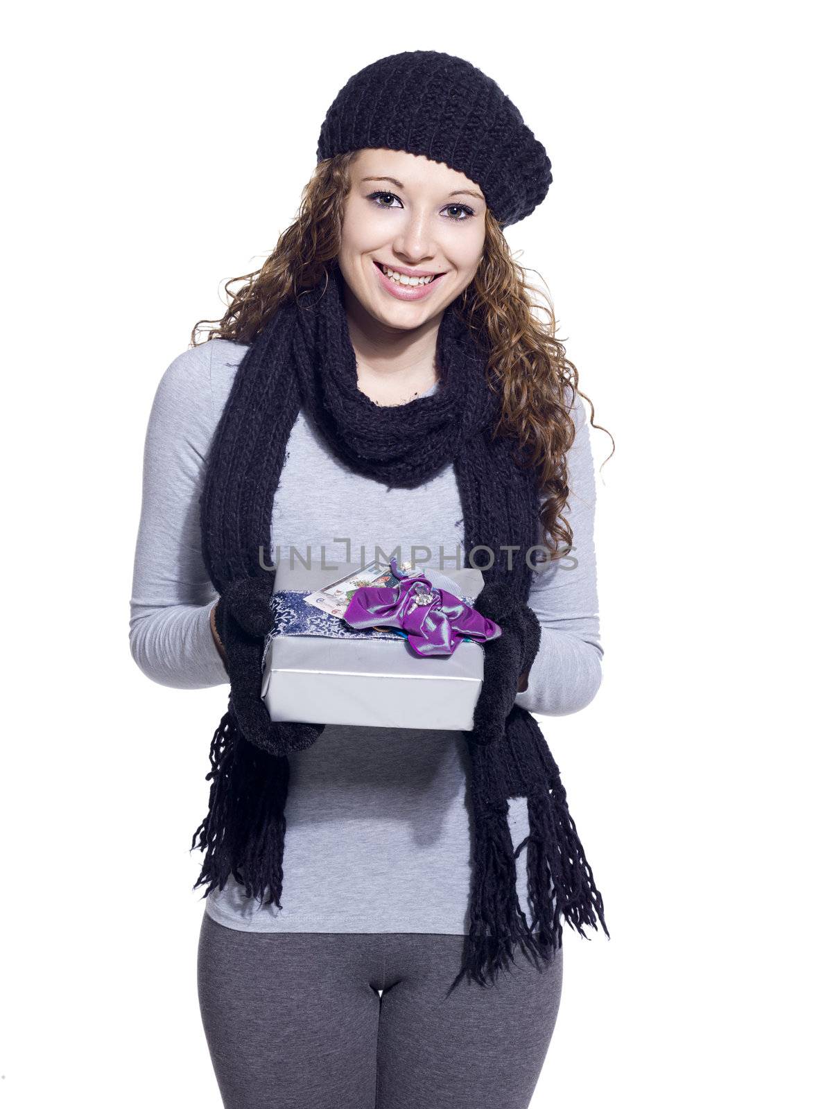 Portrait of a young woman with her Christmas present smiling while standing over white background, Model: Brittany Beaudoin