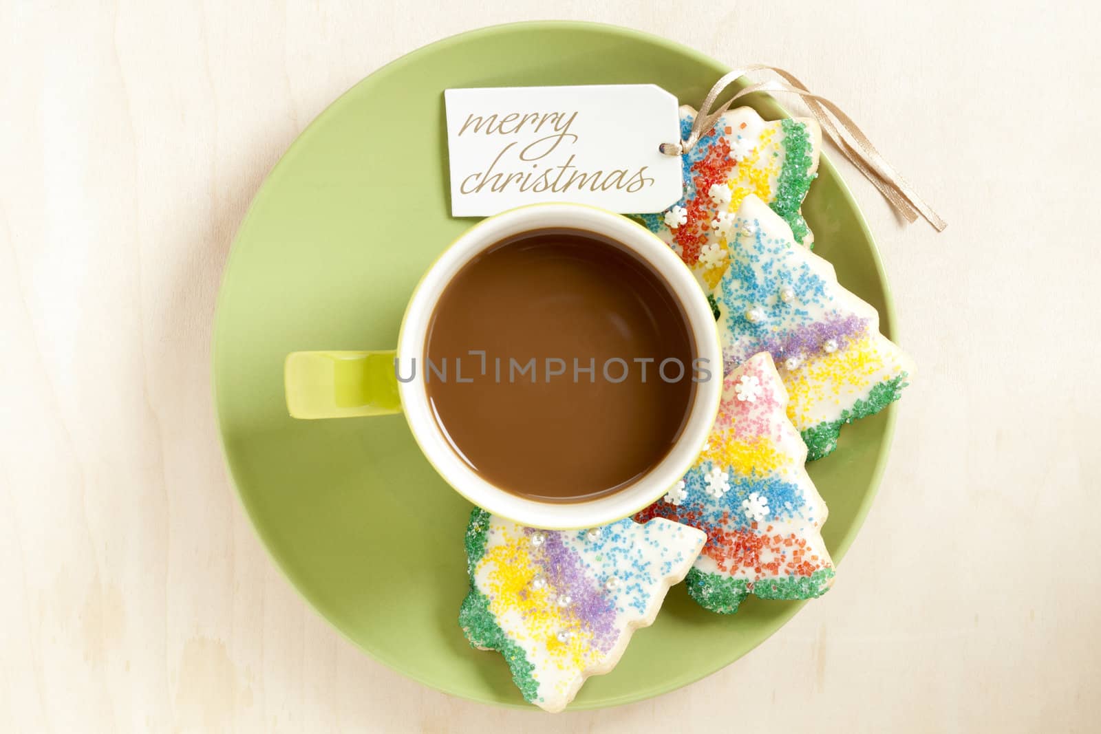 Image of hot chocolate in a cup in green saucer with christmas cookies isolated on a background