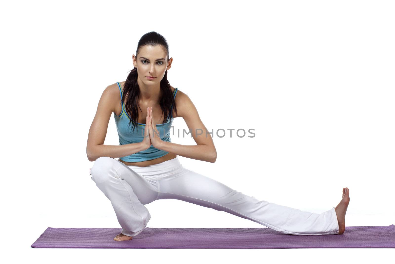 Image of  a healthy woman with her left leg stretch on the mat and facing on the camera