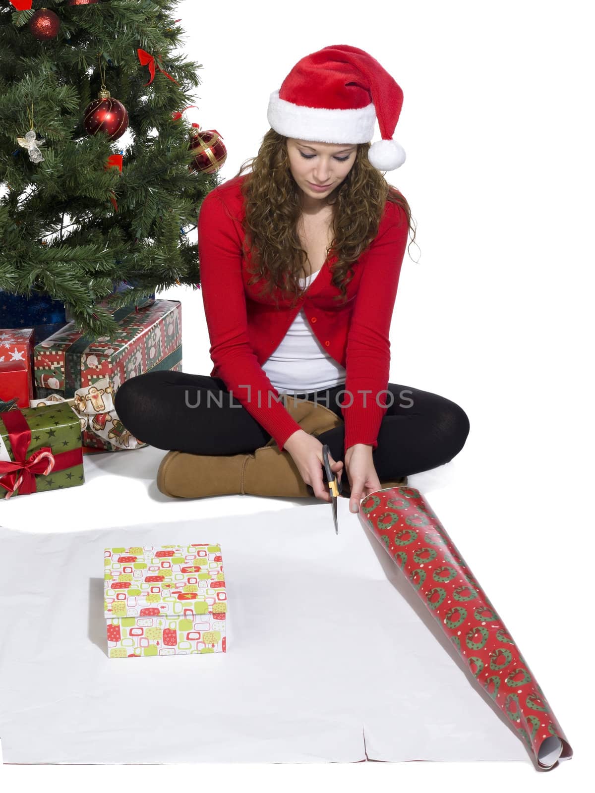 Portrait of girl sitting while starting to wrap a gift
