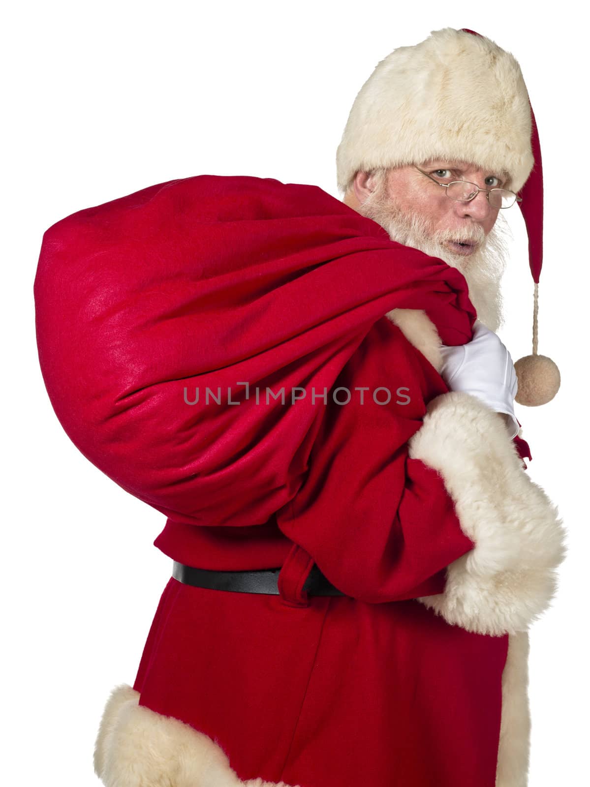 Santa Claus carrying big bag on a side view image