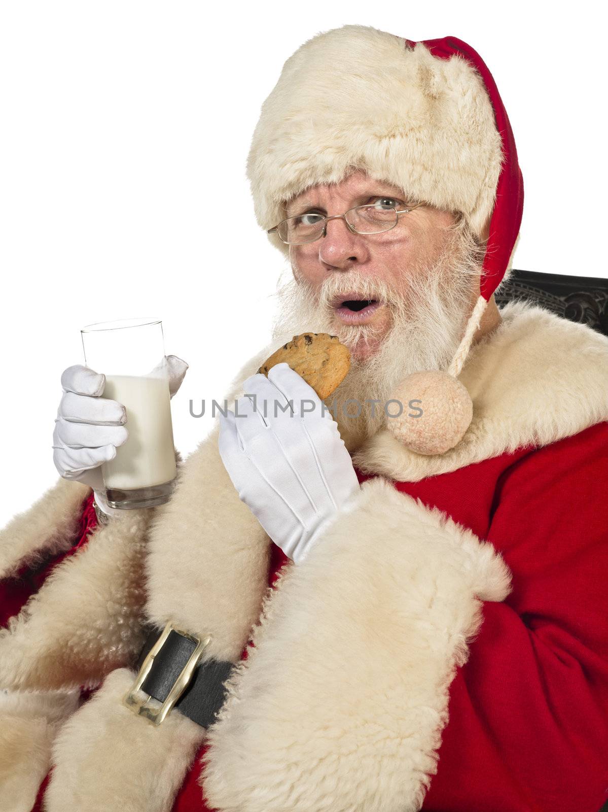 Portrait of santa claus drinking milk and eating cookies