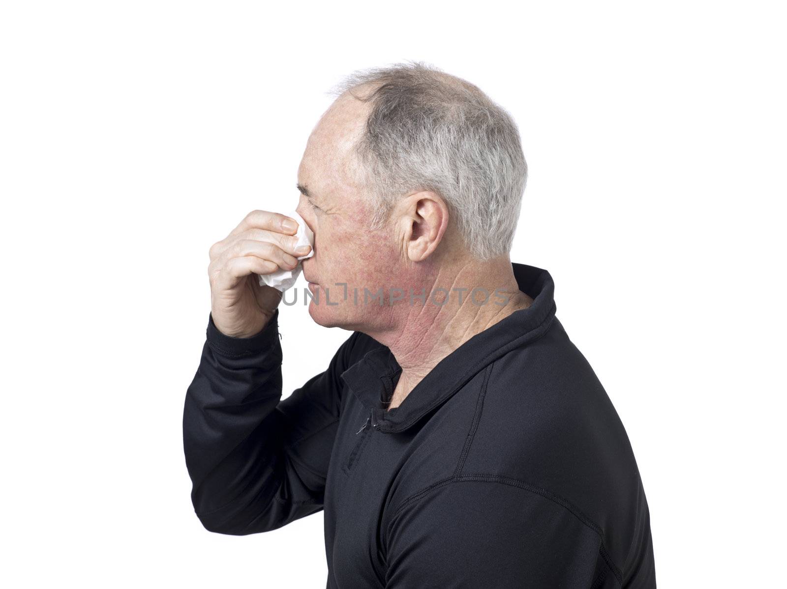 Old man sneezing in a handkerchief and getting unwell