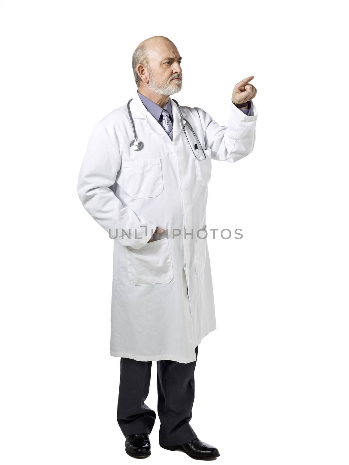 Portrait of a male doctor wearing medical suit pointing to the side of a white background 