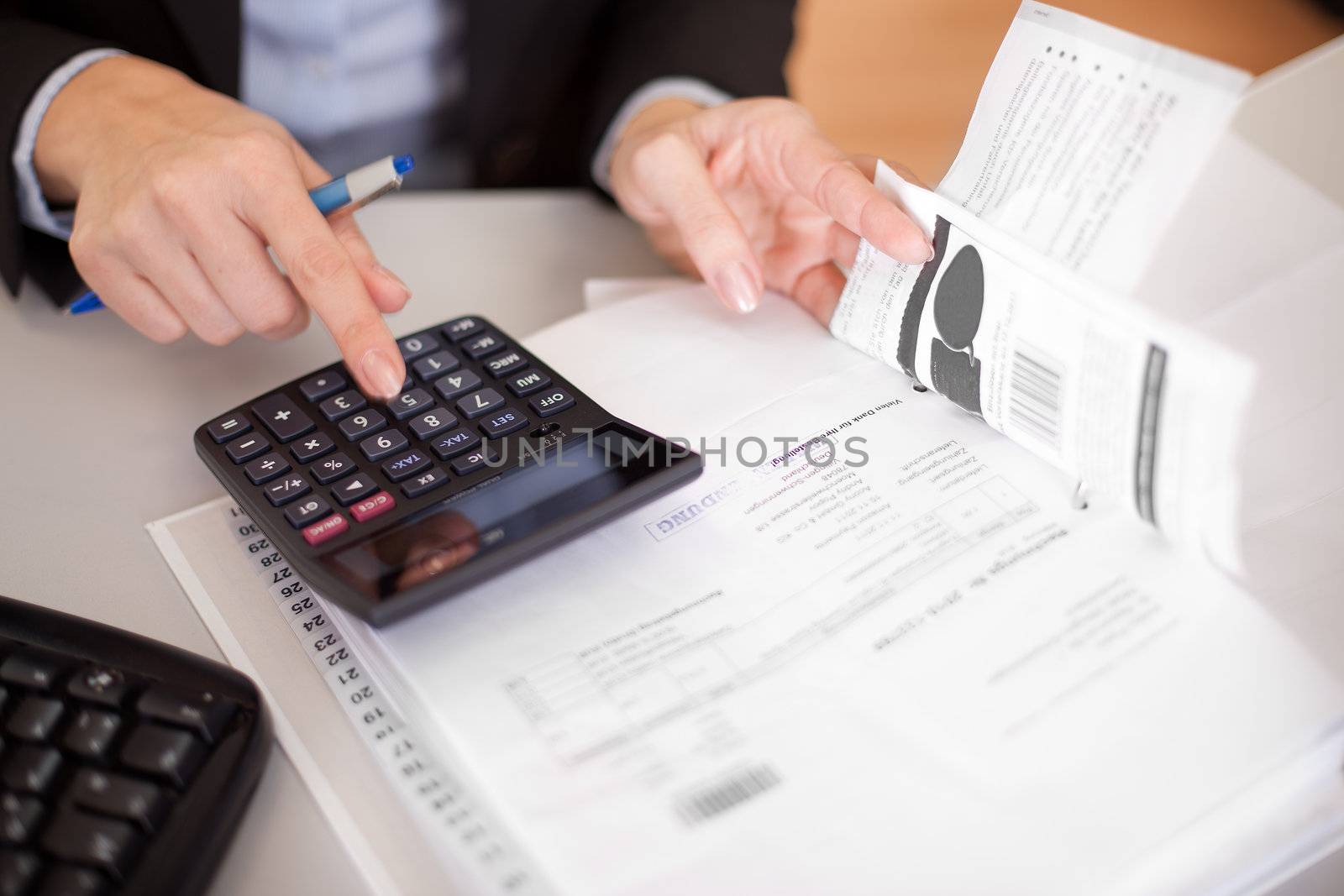 Beautiful businesswoman doing finances in the office