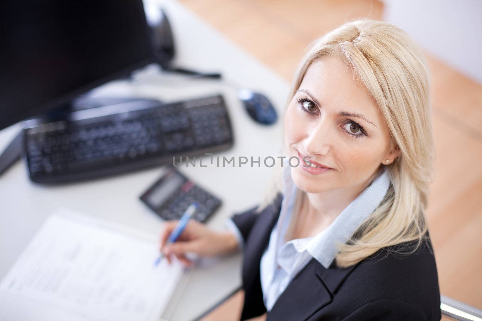 Beautiful businesswoman doing finances in the office