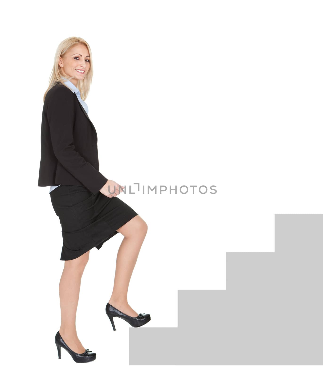 Successful businesswoman walking up a staircase by AndreyPopov