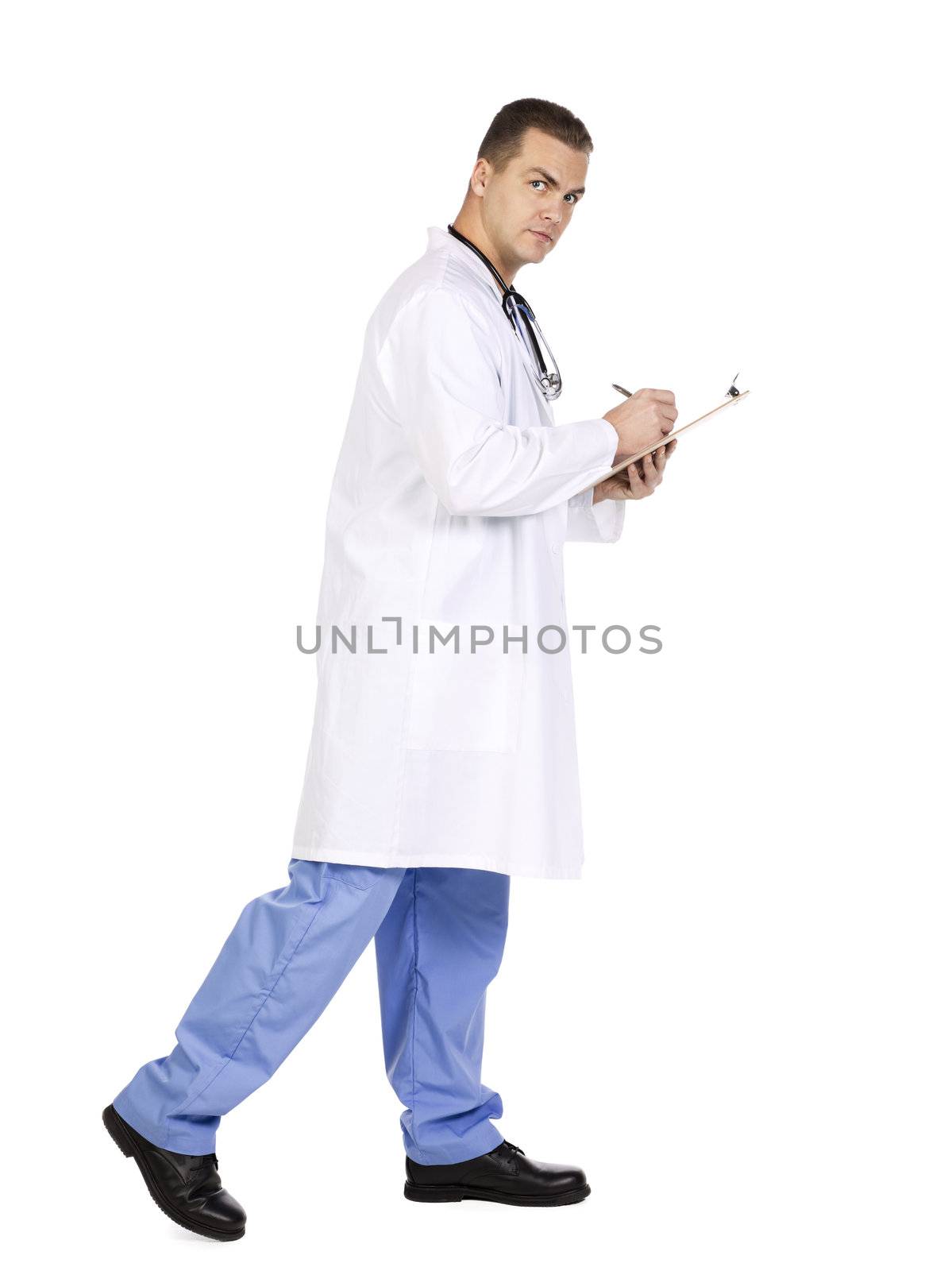 The doctor is walking and writing on the clipboard isolated on white