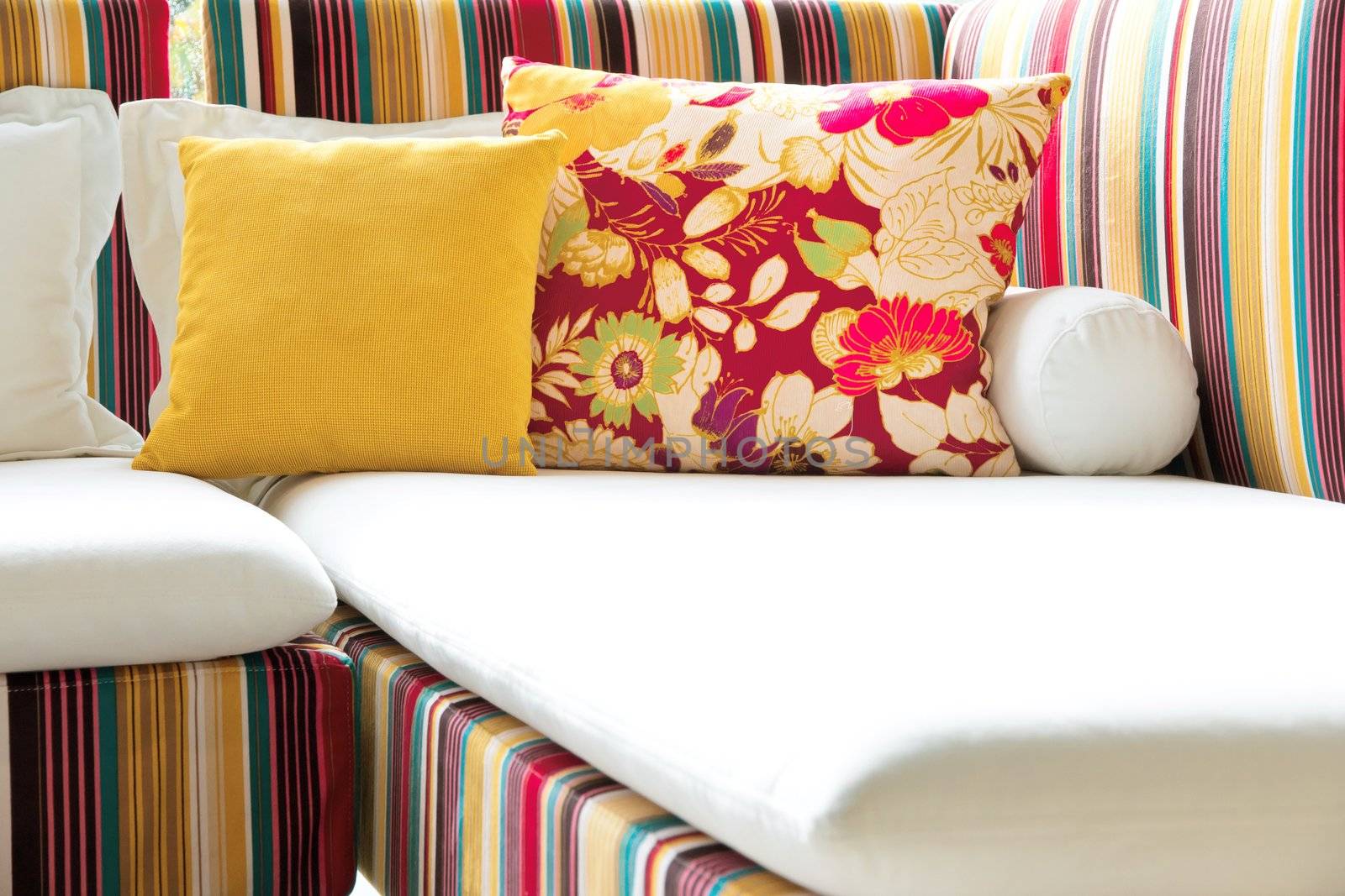 Colorful cushions in sofa. by ponsulak