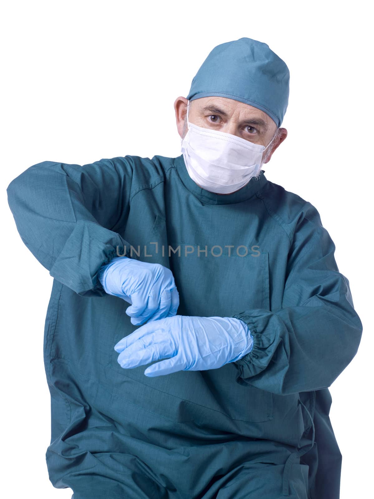  Portrait of a surgeon doctor wearing a sterile blue gown and preparing himself against white background
