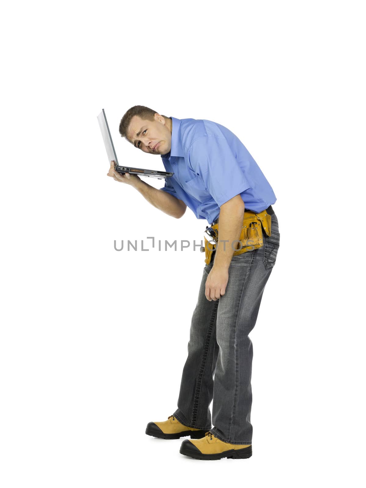Image of an unhappy construction worker with his head in laptop. Model: Denis Bryzgounov