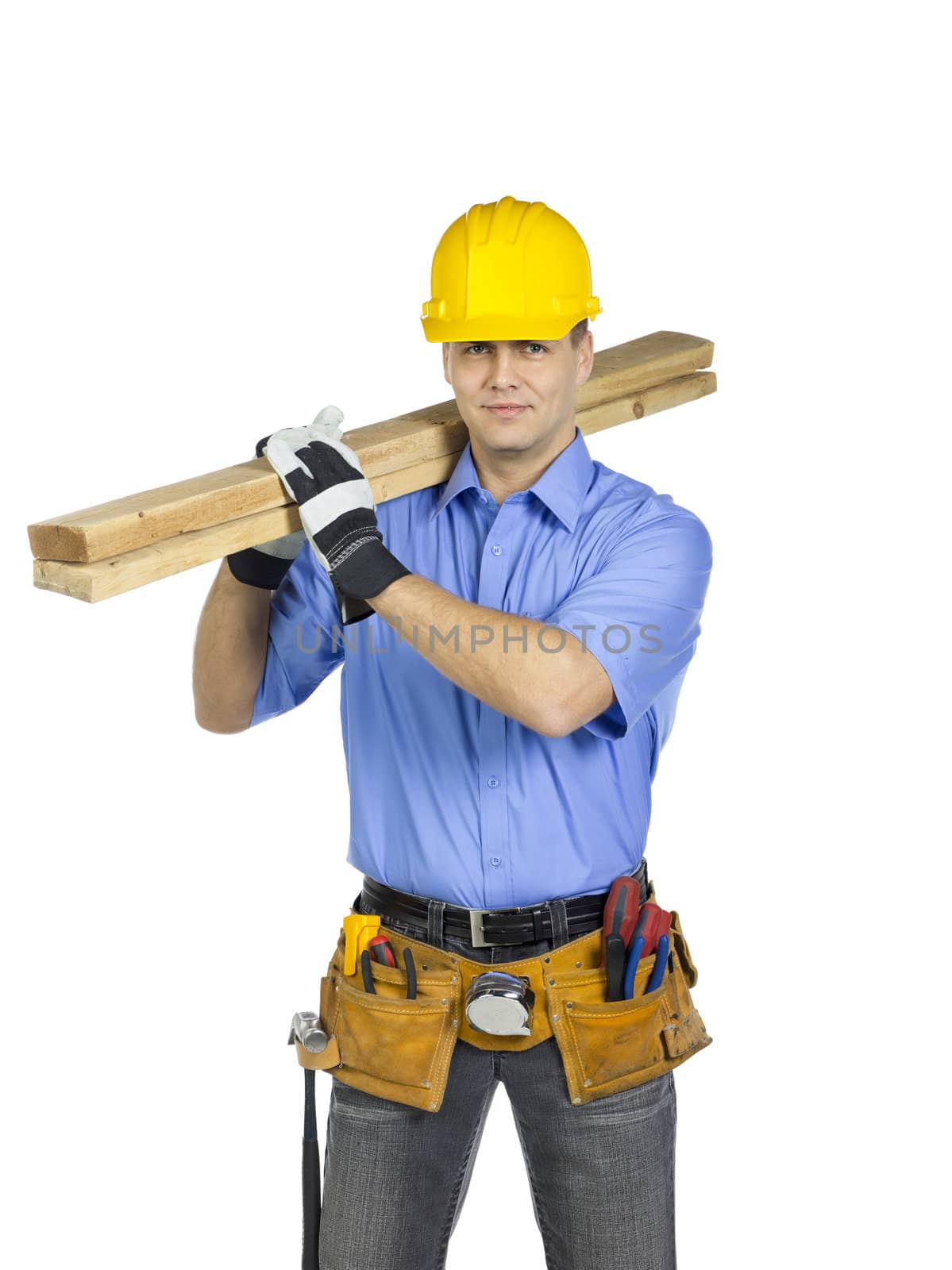 Construction worker wearing a hard hat holding a wood on his shoulder