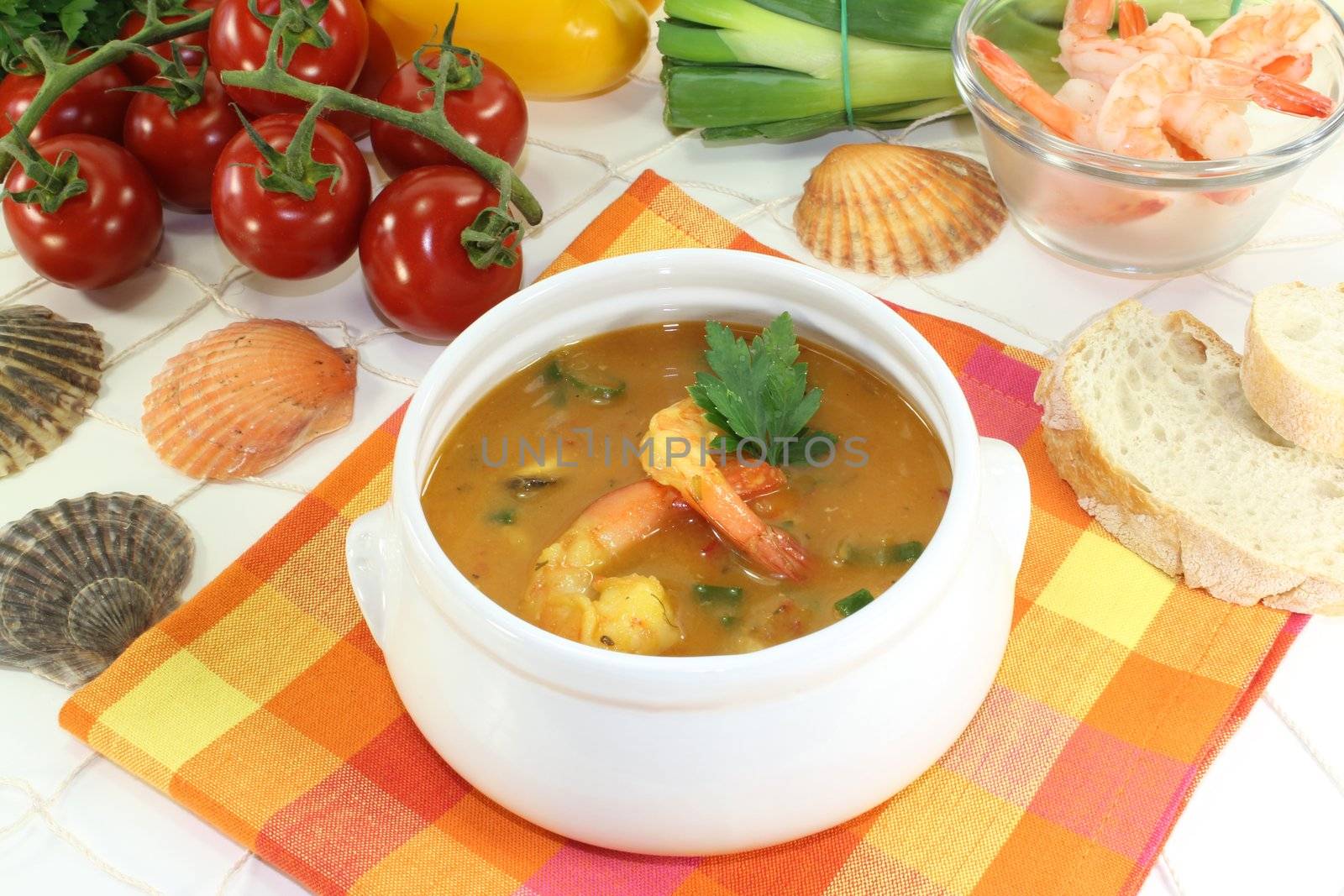 healthy bouillabaisse with seafood and parsley on a light background