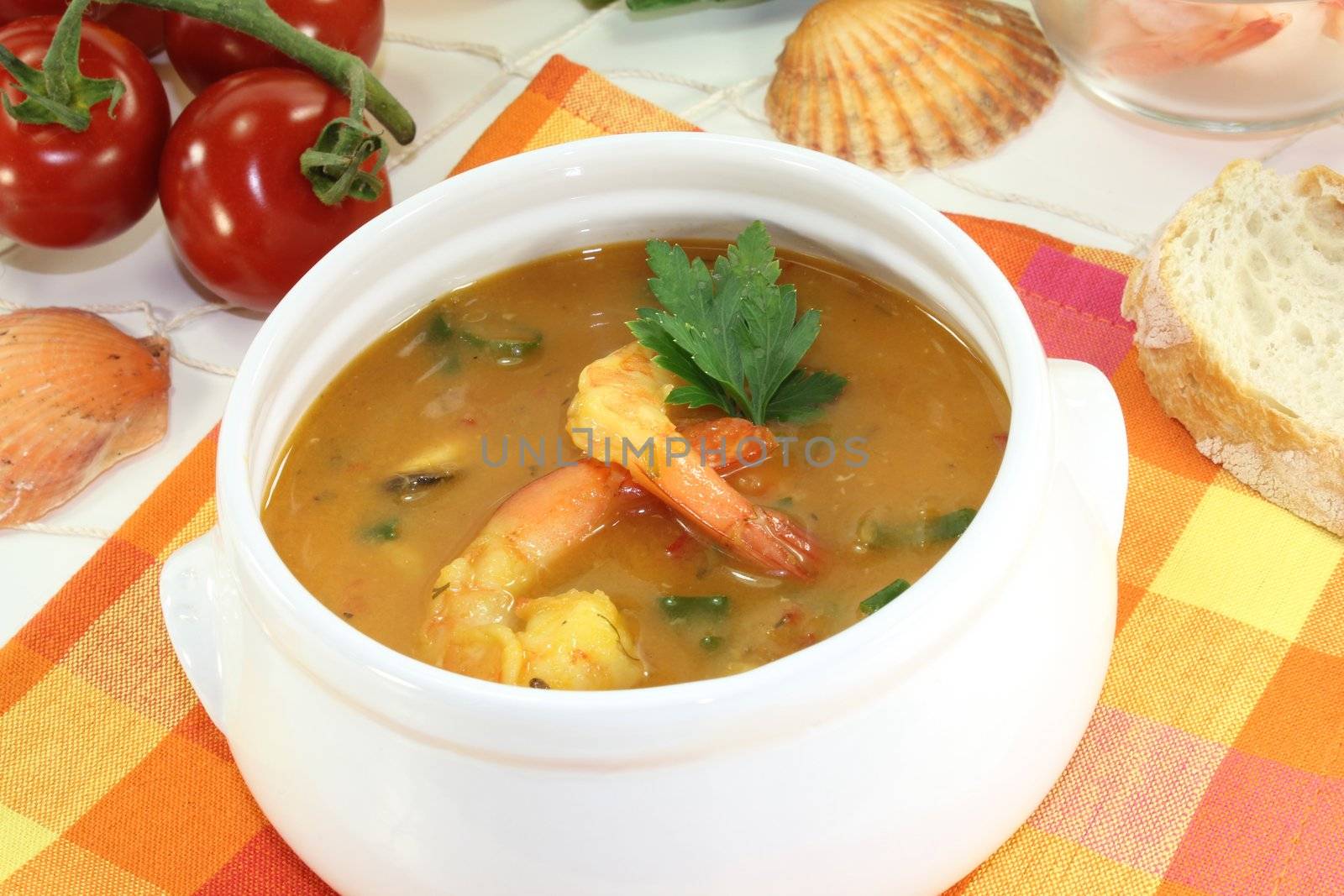 fresh bouillabaisse with seafood and parsley on a light background