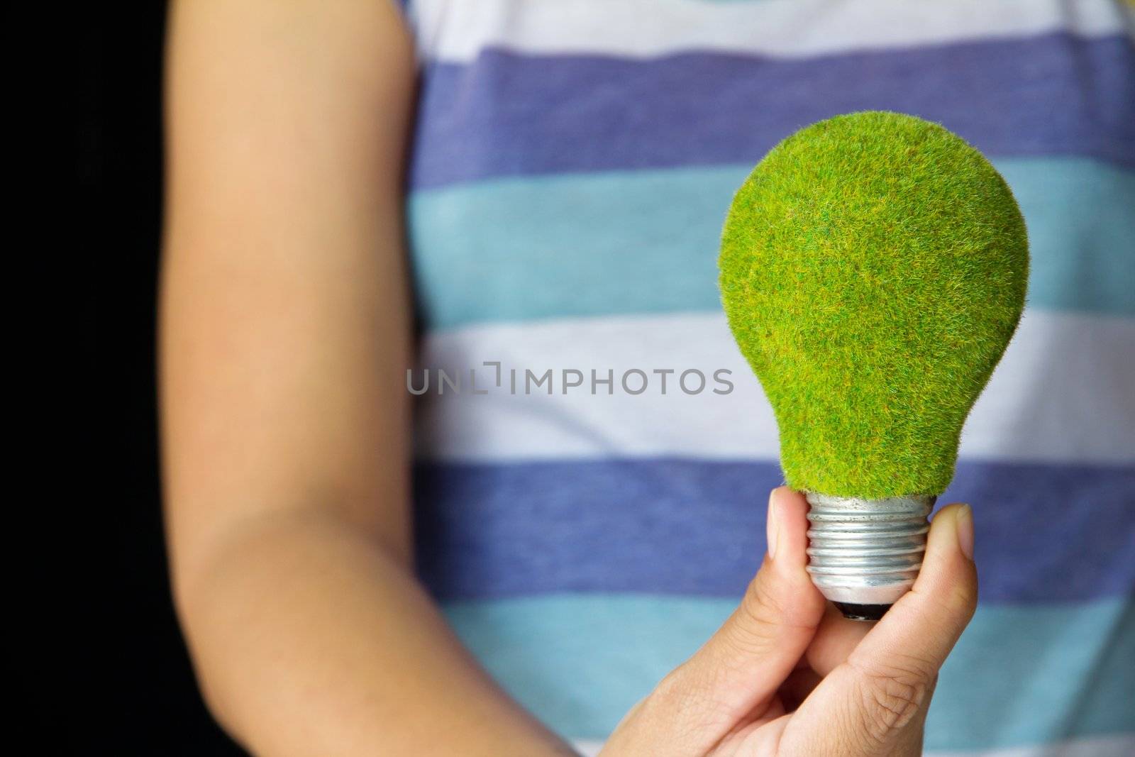 hand holding eco light bulb by ponsulak