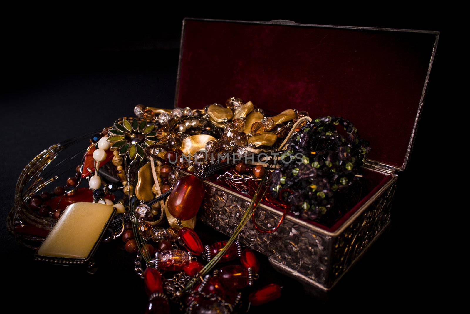 Silver treasure box in the dark, full of necklaces and jewelery