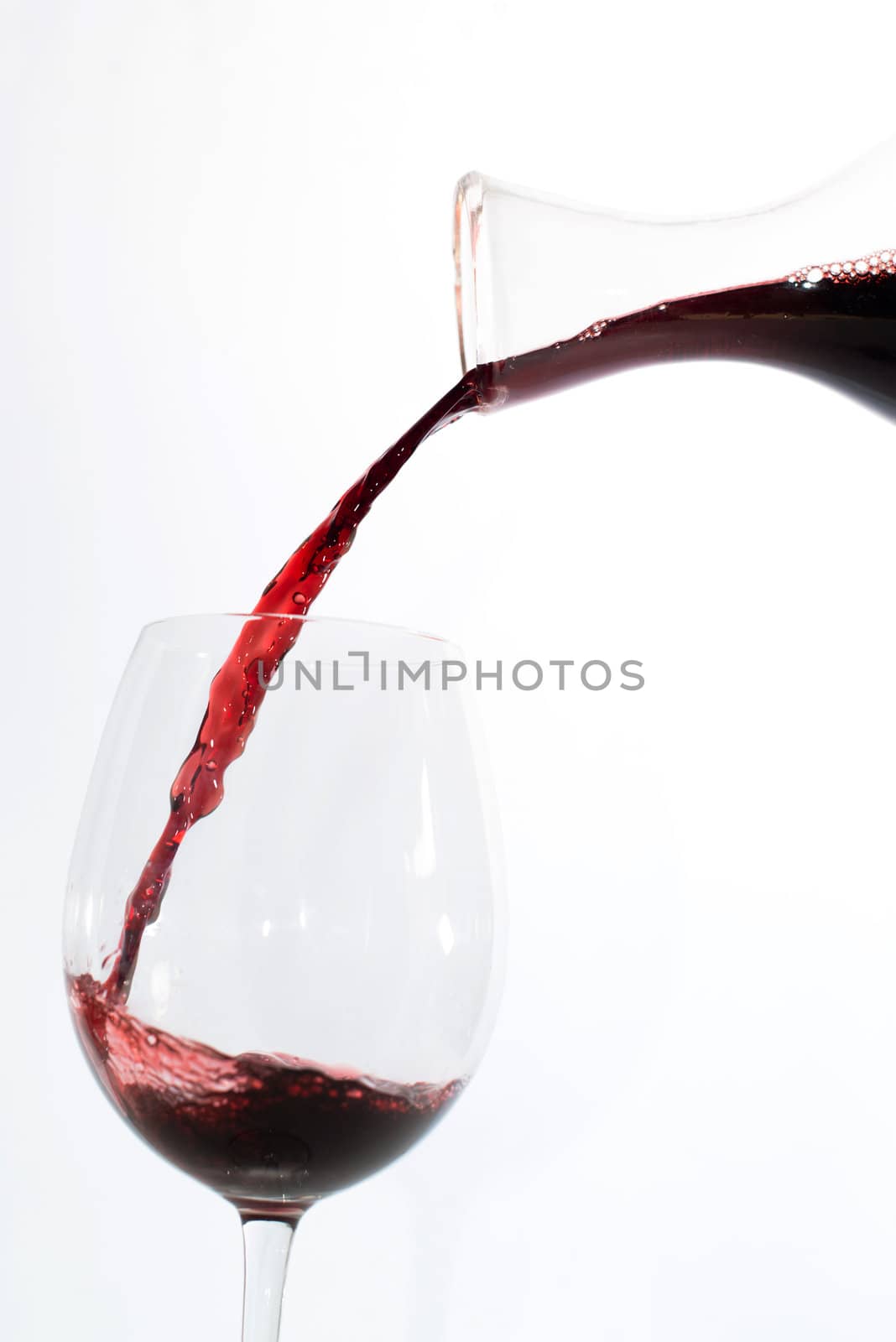 Red wine pouring into a glass by franky242