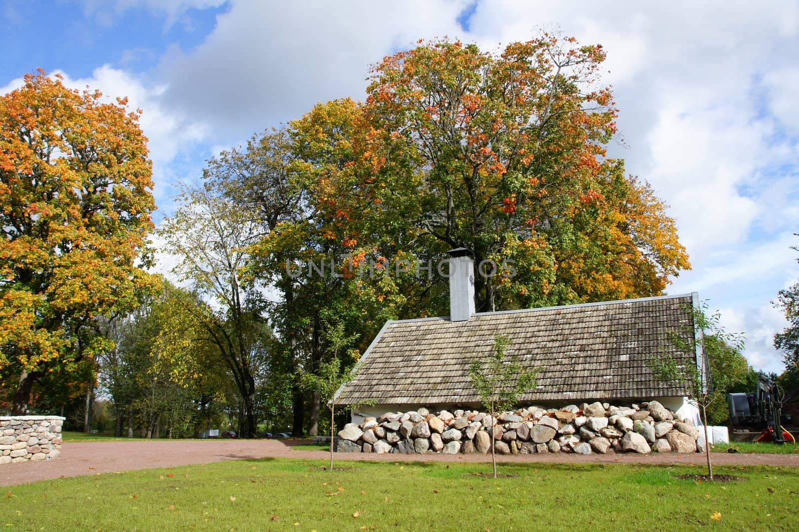 Old stone shed on a background of trees