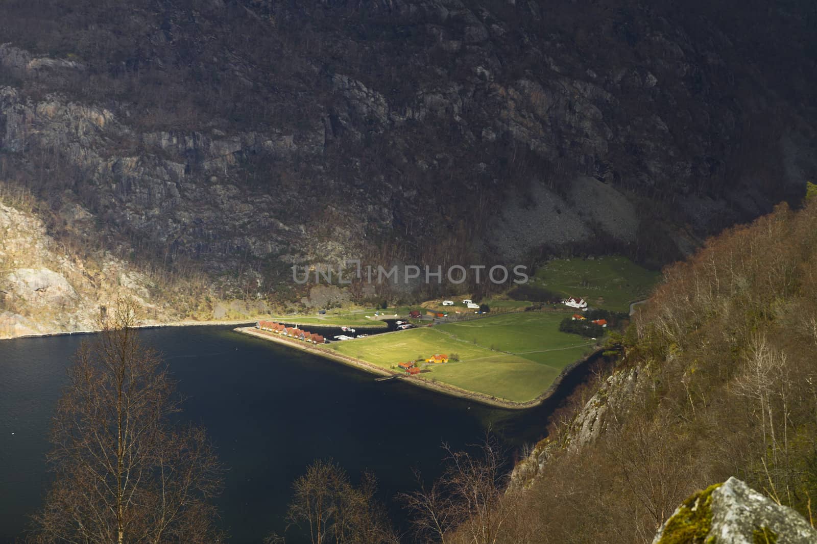 small, deep fjord in norway in changeful weather with cloudy sky