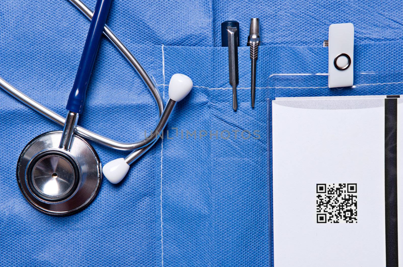 Closeup photo of a doctor pocket with pens, an ID card and a stethoscope close by