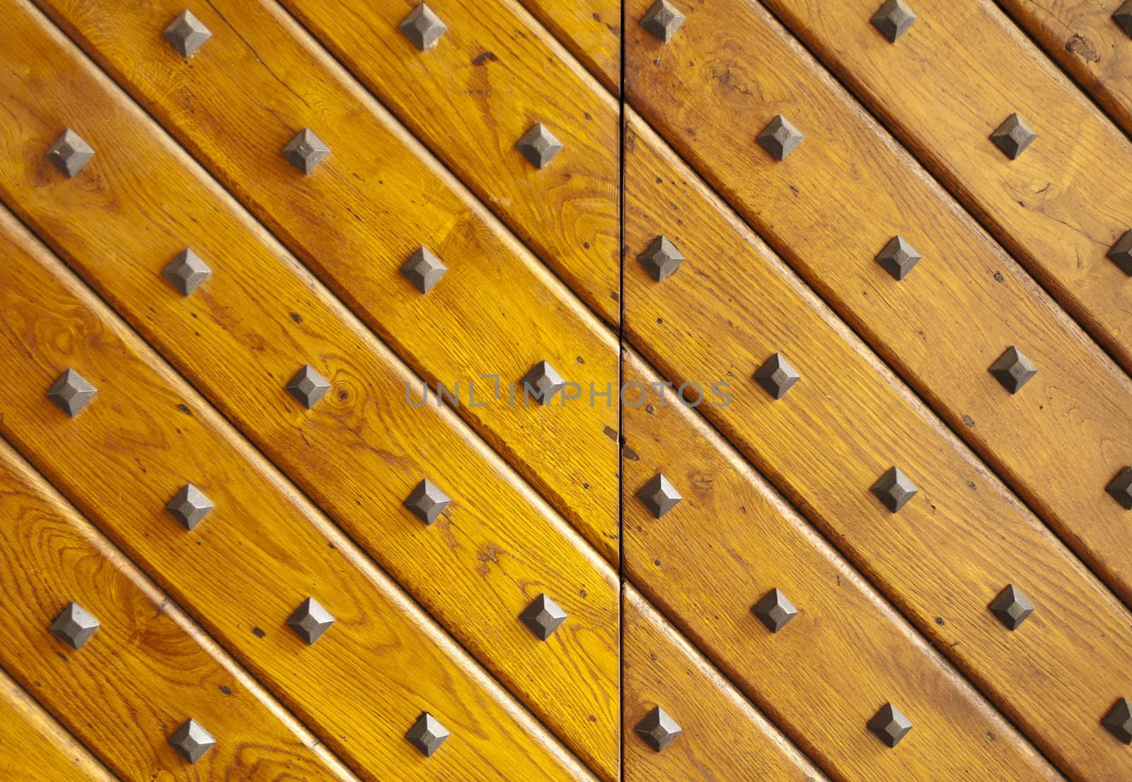 Wooden texture with nails. Ancient wooden gate door.