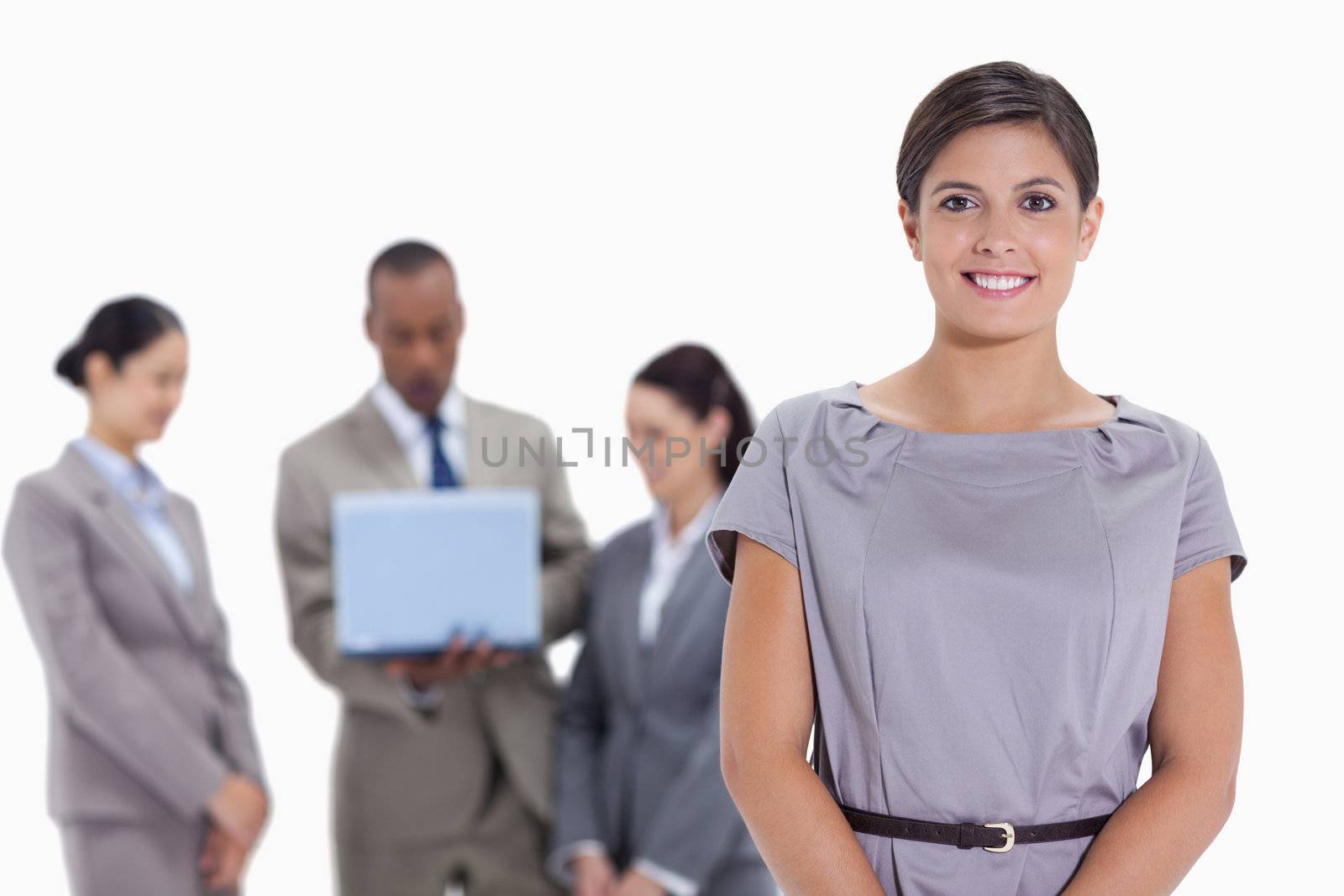 Woman business team in the background watching a laptop by Wavebreakmedia