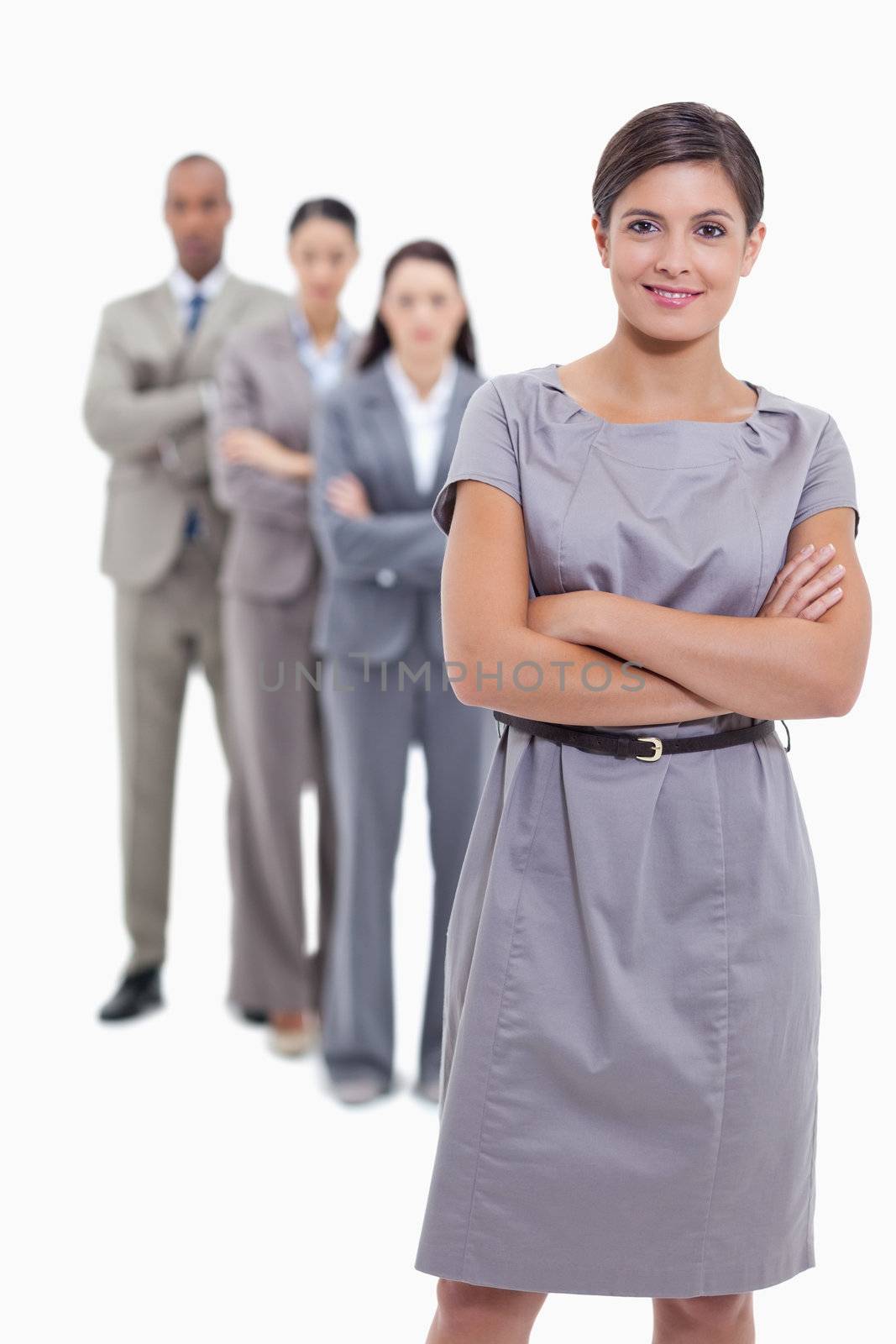 Woman smiling with her business team crossing their arms by Wavebreakmedia