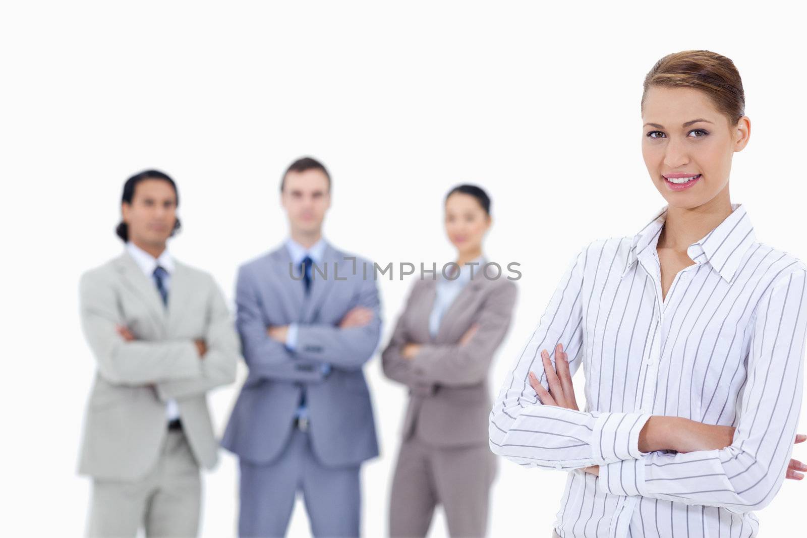 Close-up of a secretary smiling with business people crossing th by Wavebreakmedia