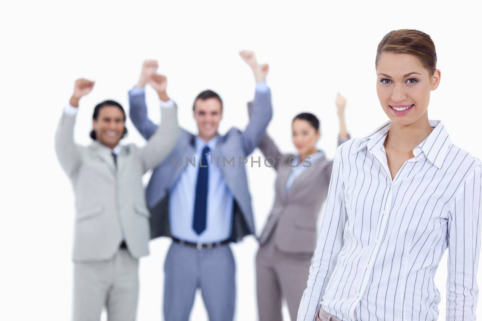 Close-up of a secretary smiling and business people with the thumbs up in the background