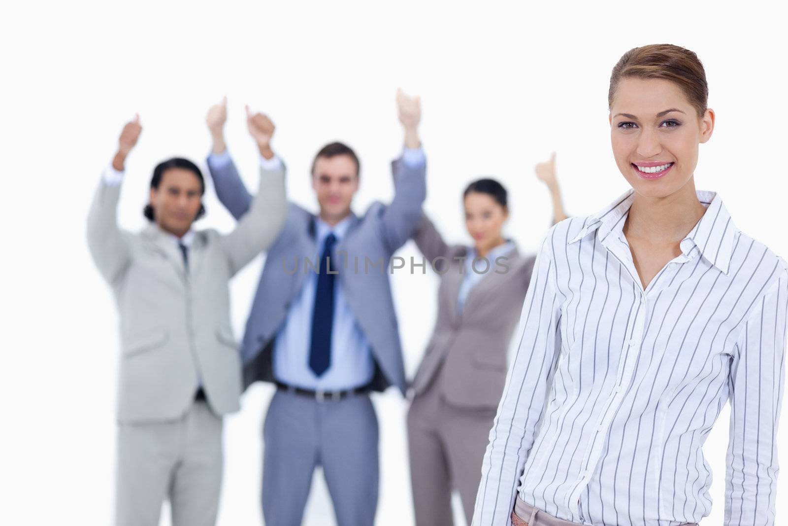 Close-up of a secretary smiling with enthusiastic business peopl by Wavebreakmedia