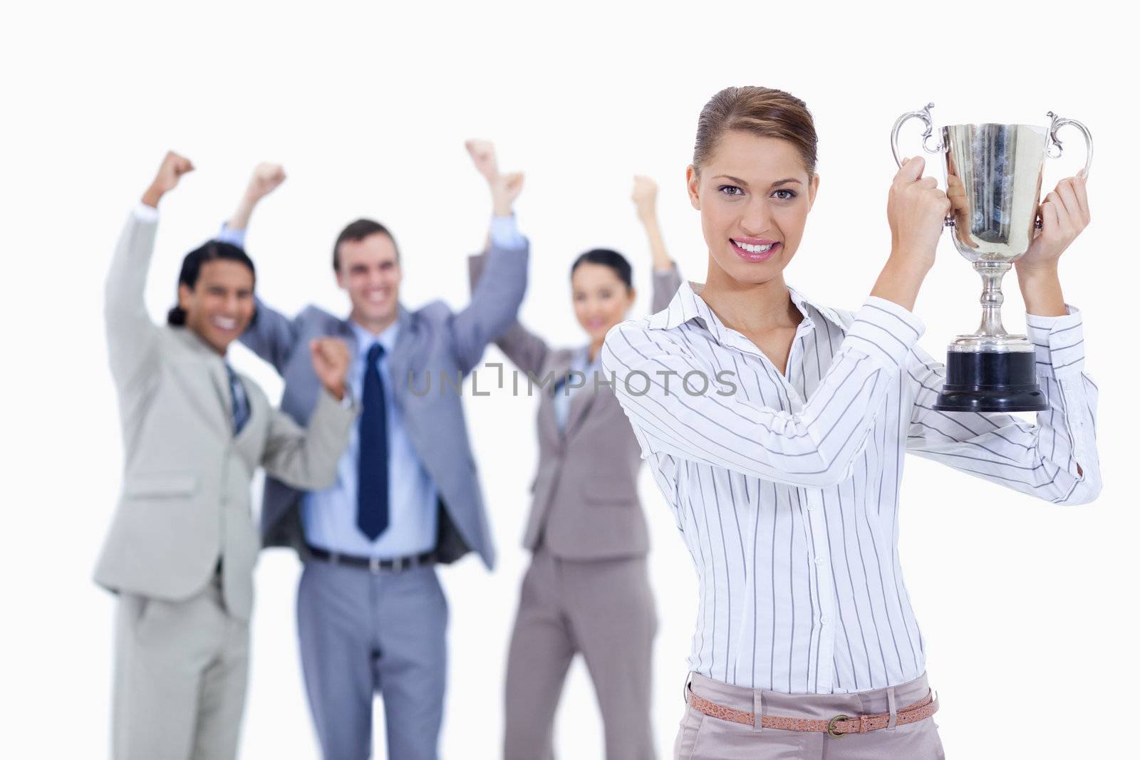 Close-up of a woman holding a cup with people dressed in suits a by Wavebreakmedia