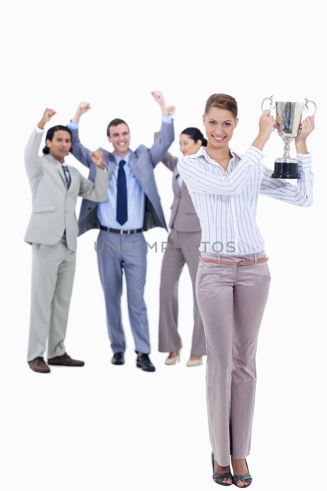 Woman holding a cup with people dressed in suits acclaiming  by Wavebreakmedia