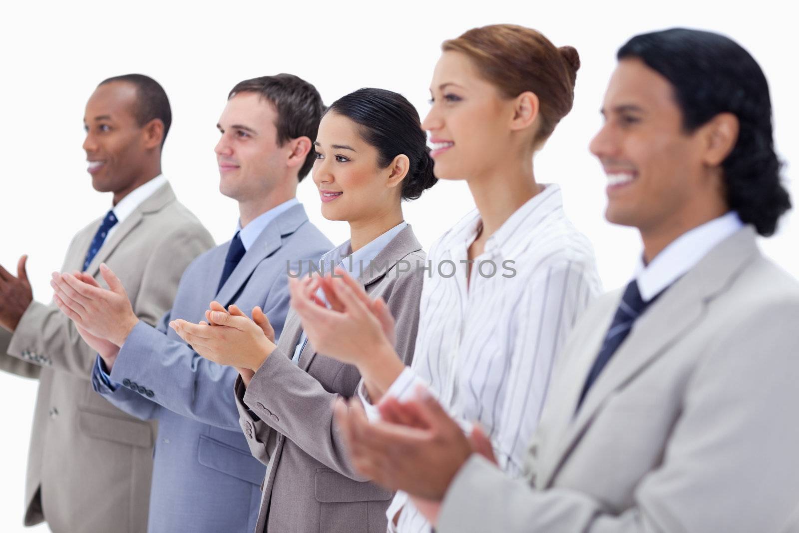 Close-up of a business team smiling and applauding  by Wavebreakmedia