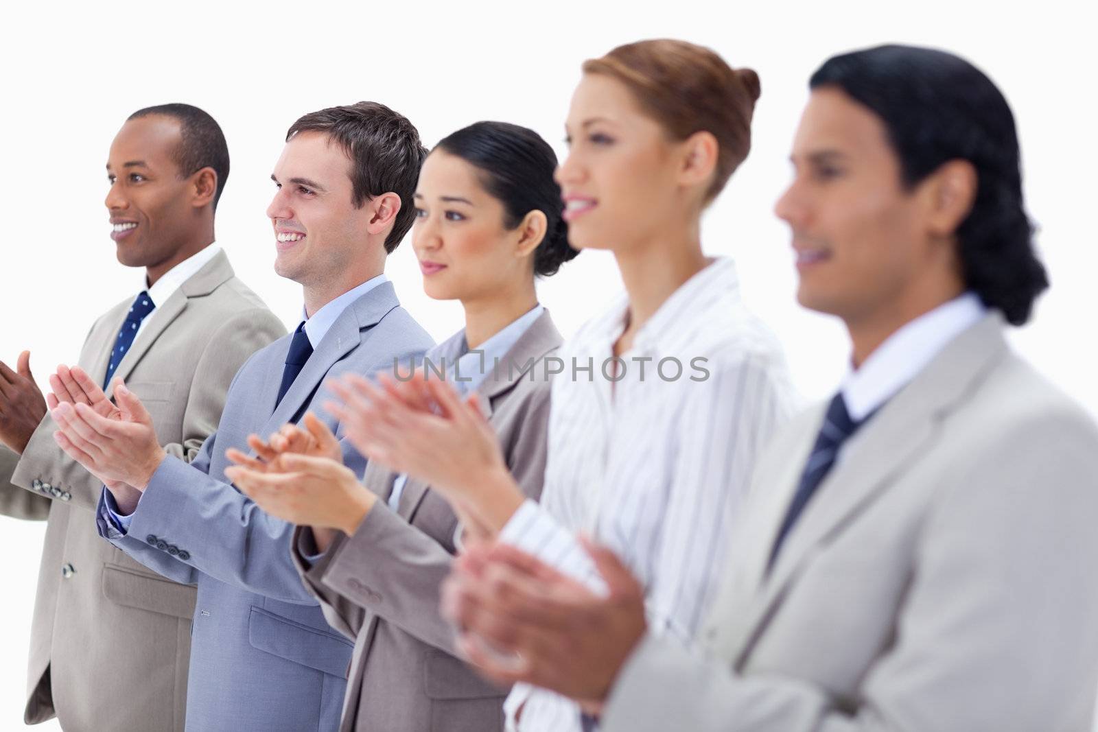 Close-up of people dressed in suits smiling and applauding  by Wavebreakmedia