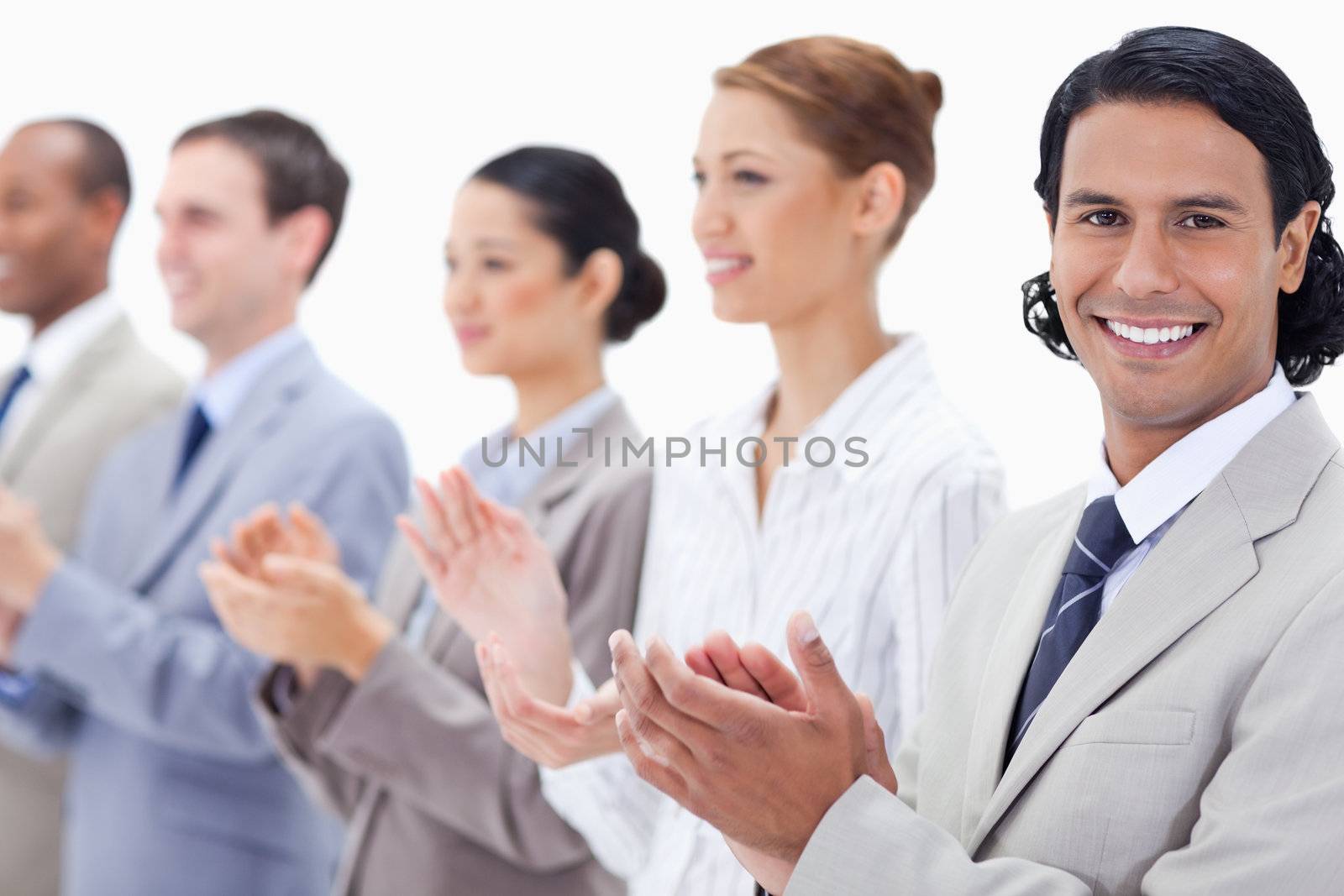 Close-up of a business team smiling and applauding  by Wavebreakmedia