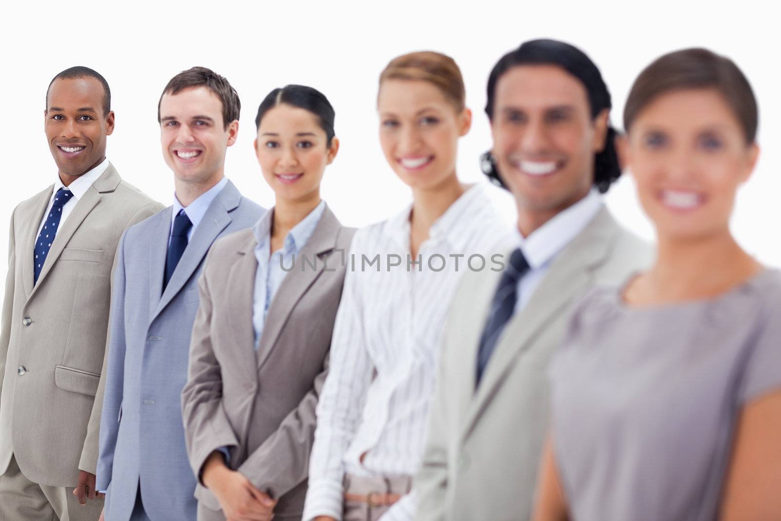 Close-up of happy business people looking straight with focus on the last three people