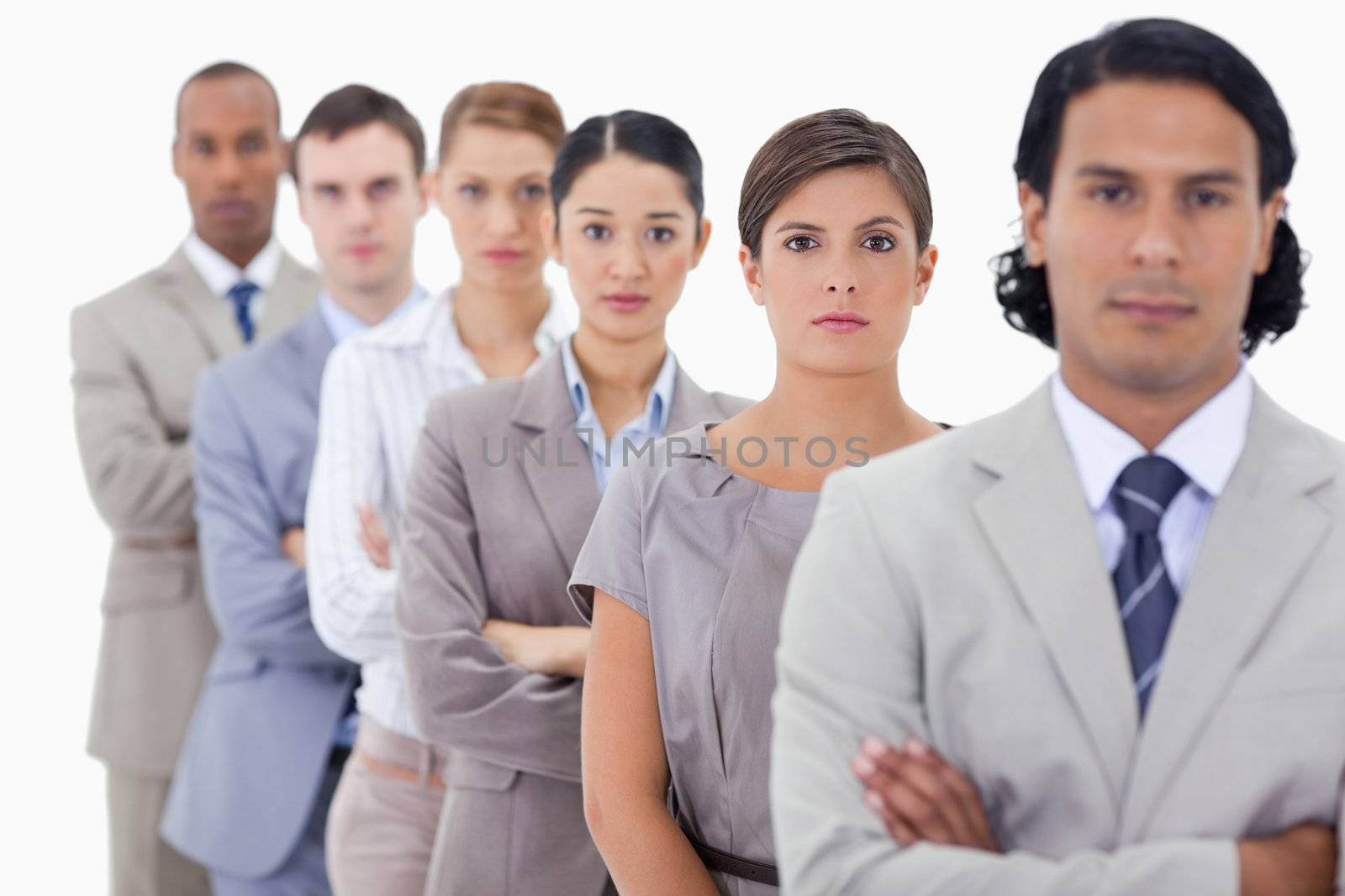 Big close-up of determined colleagues in a single line with focus on the first woman