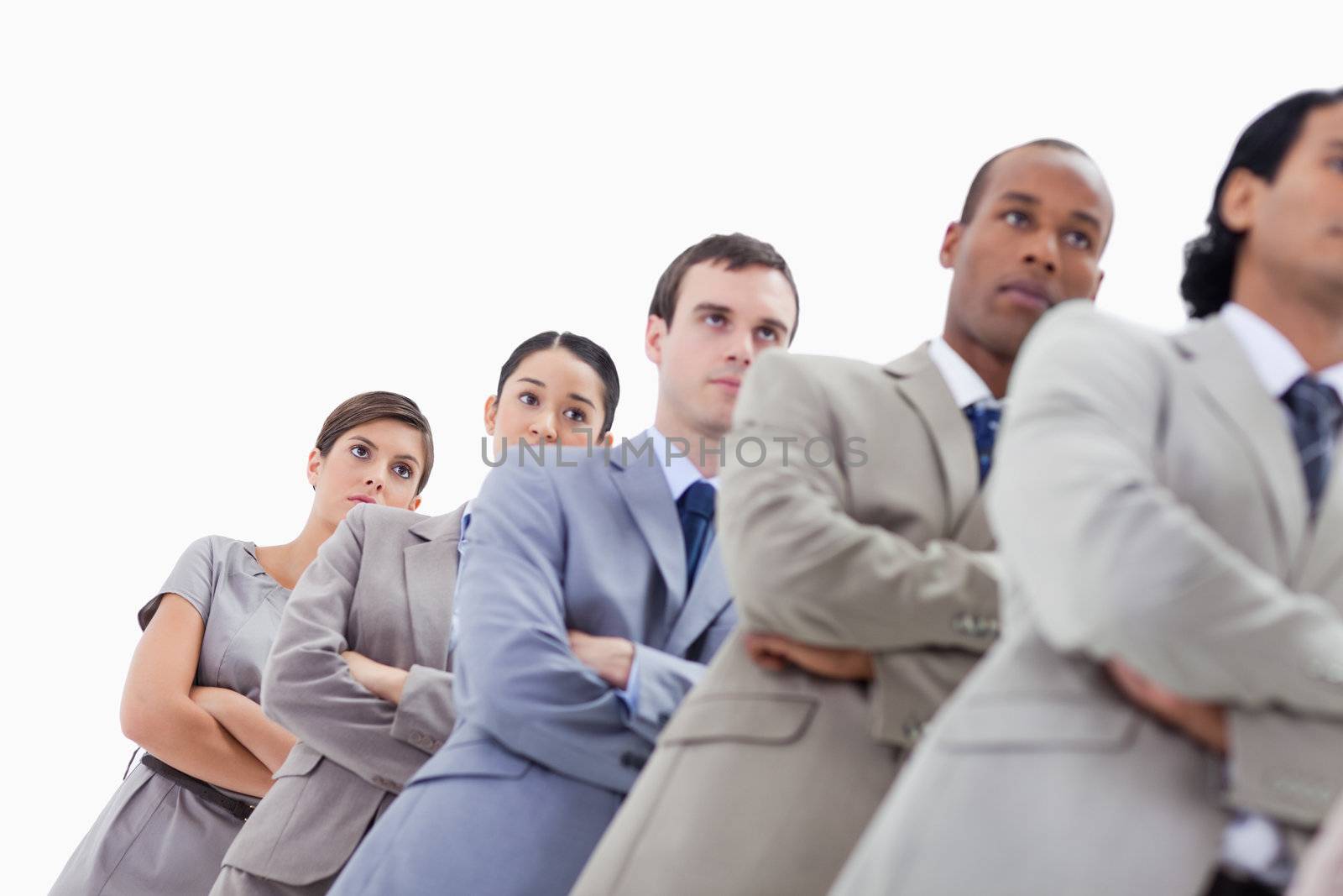 Low-angle shot of colleagues crossing their arms in a single line with focus on the last two women