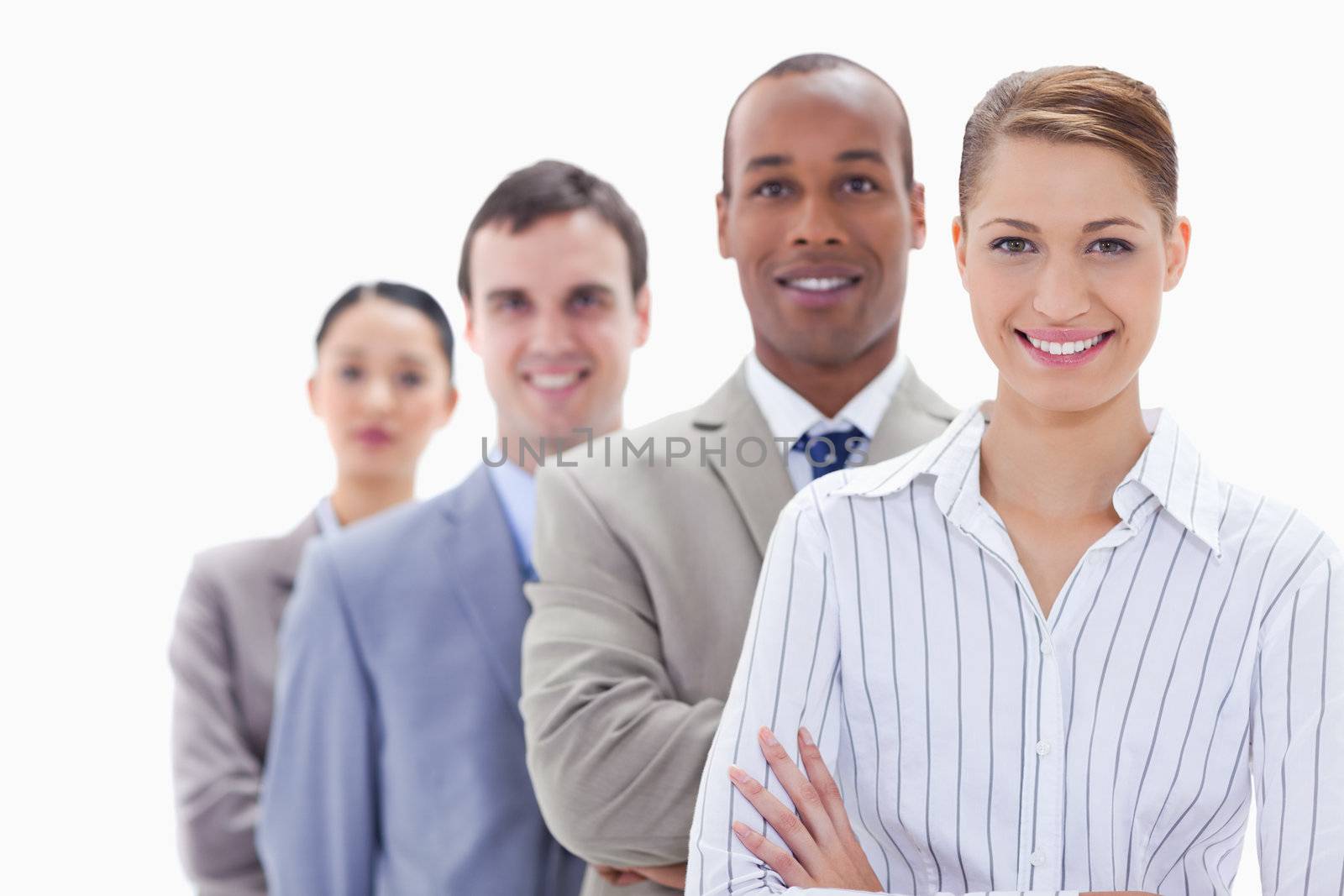 Close-up of a business team smiling in a single line with focus on the first woman