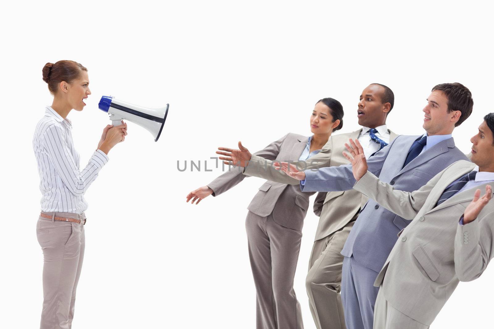 Woman yelling at people dressed in suits through a megaphone by Wavebreakmedia
