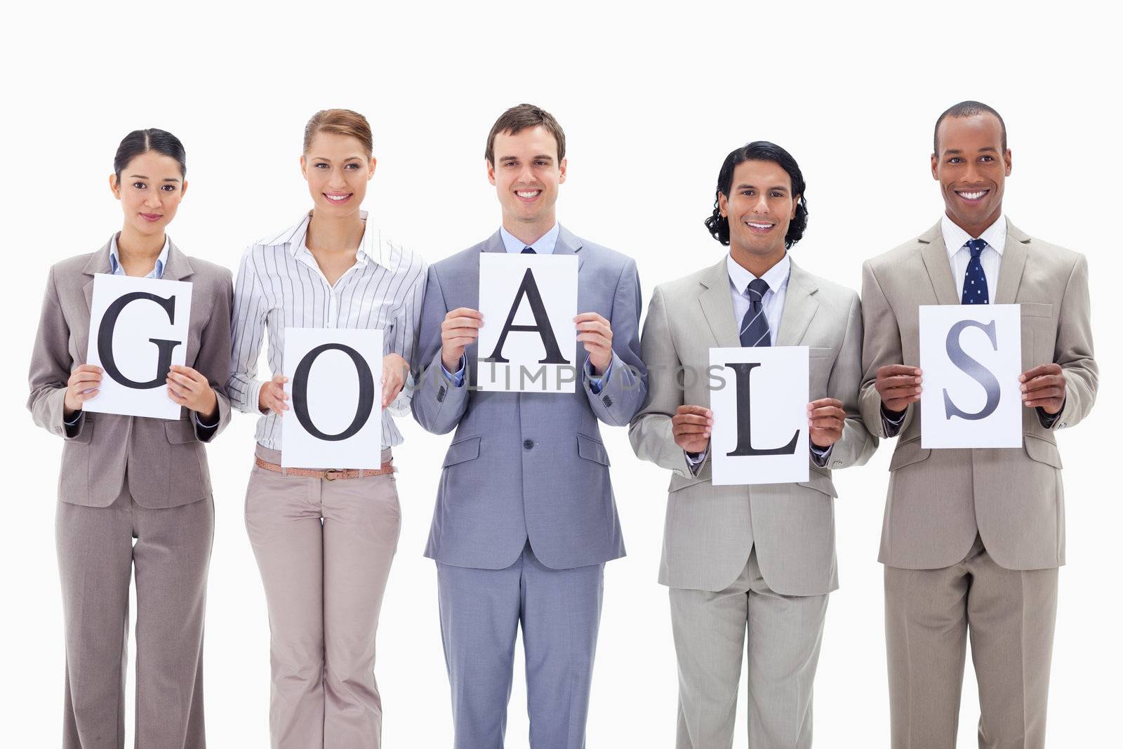 Business team holding the letters of GOALS against white background