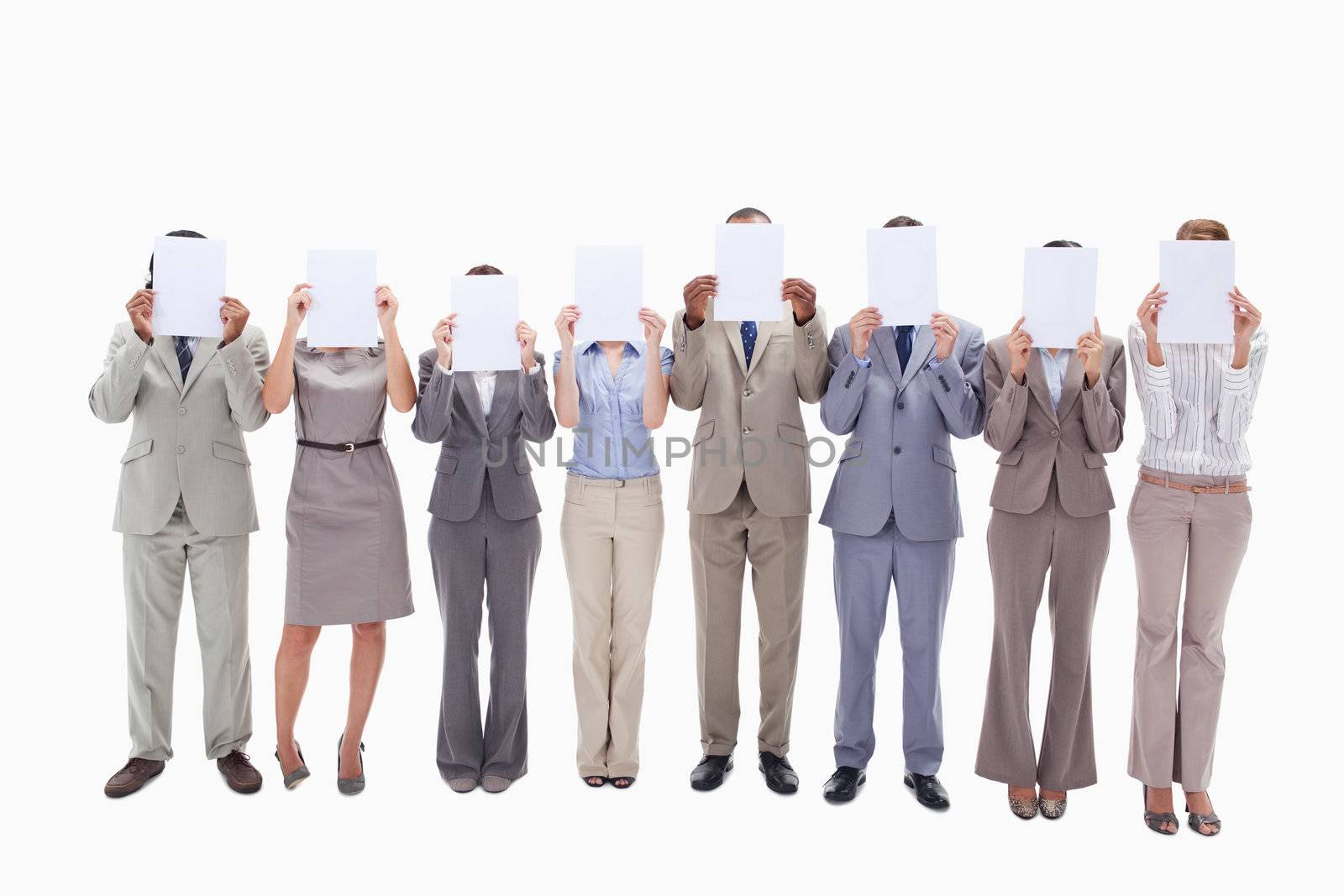 Business people hiding their faces with support for letters by Wavebreakmedia