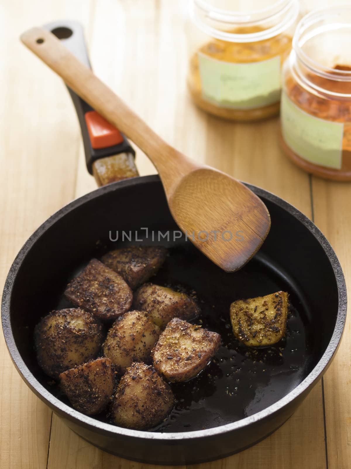 close up of a pan of indian crusty potatoes