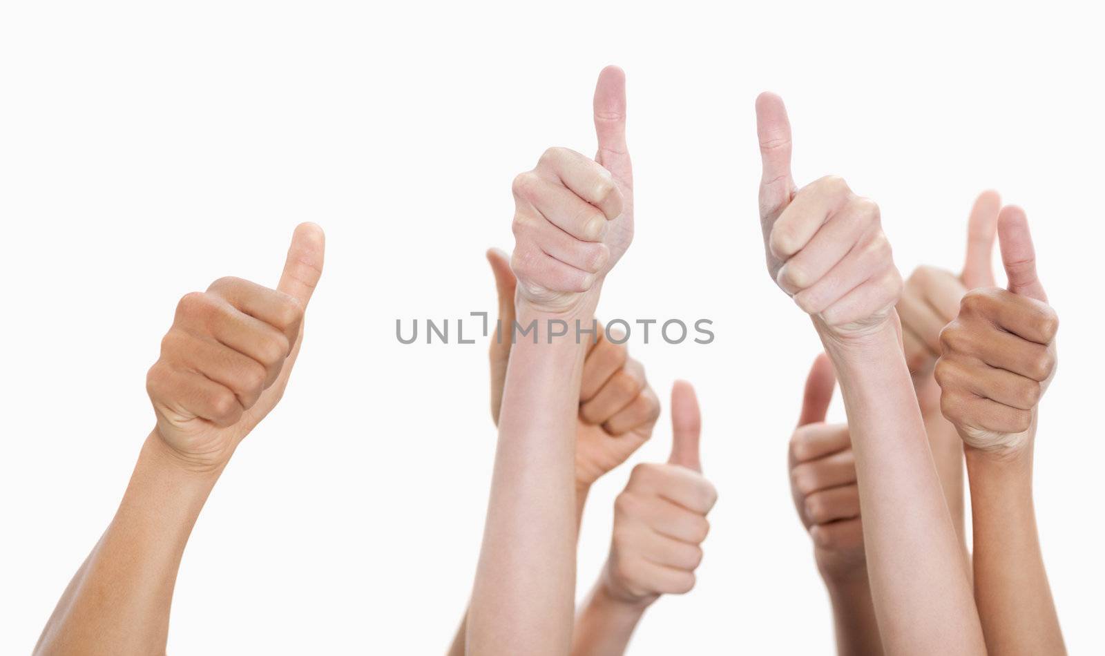 Hands up and thumbs raised against white background