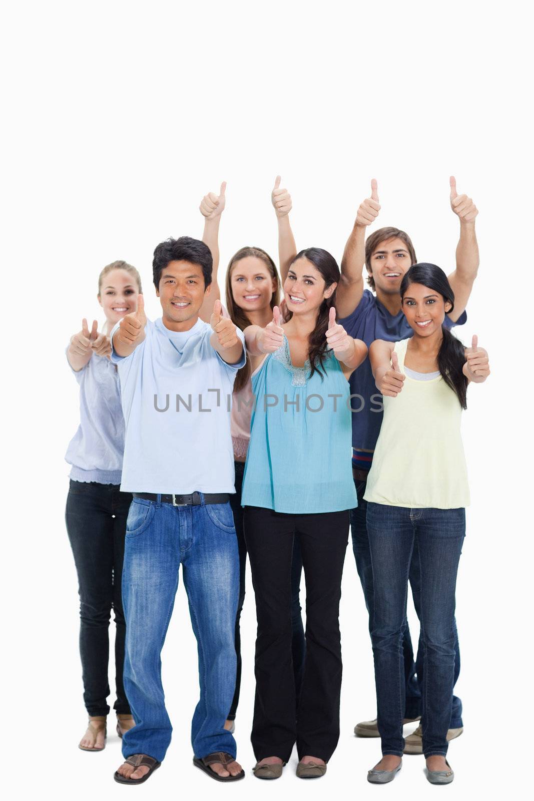 People smiling together and approving with the thumbs-up by Wavebreakmedia