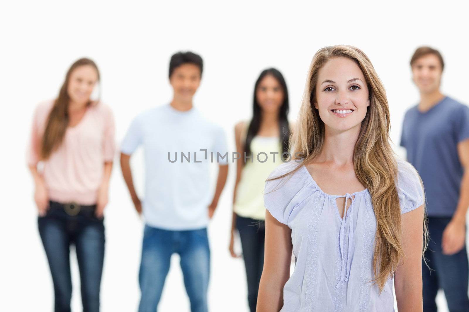 People smiling with one woman in foreground by Wavebreakmedia